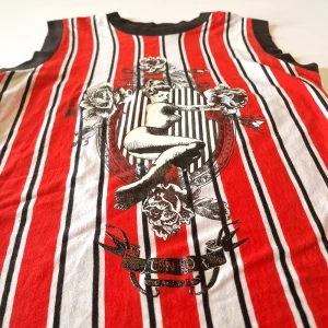Close up of a striped vest featuring an illustration of a pin up girl