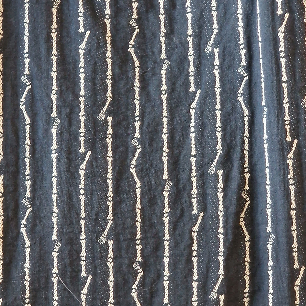 A close-up of the bone pattern of Junior Gaultier jacket.