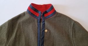 The collar and shoulders of the military jacket.