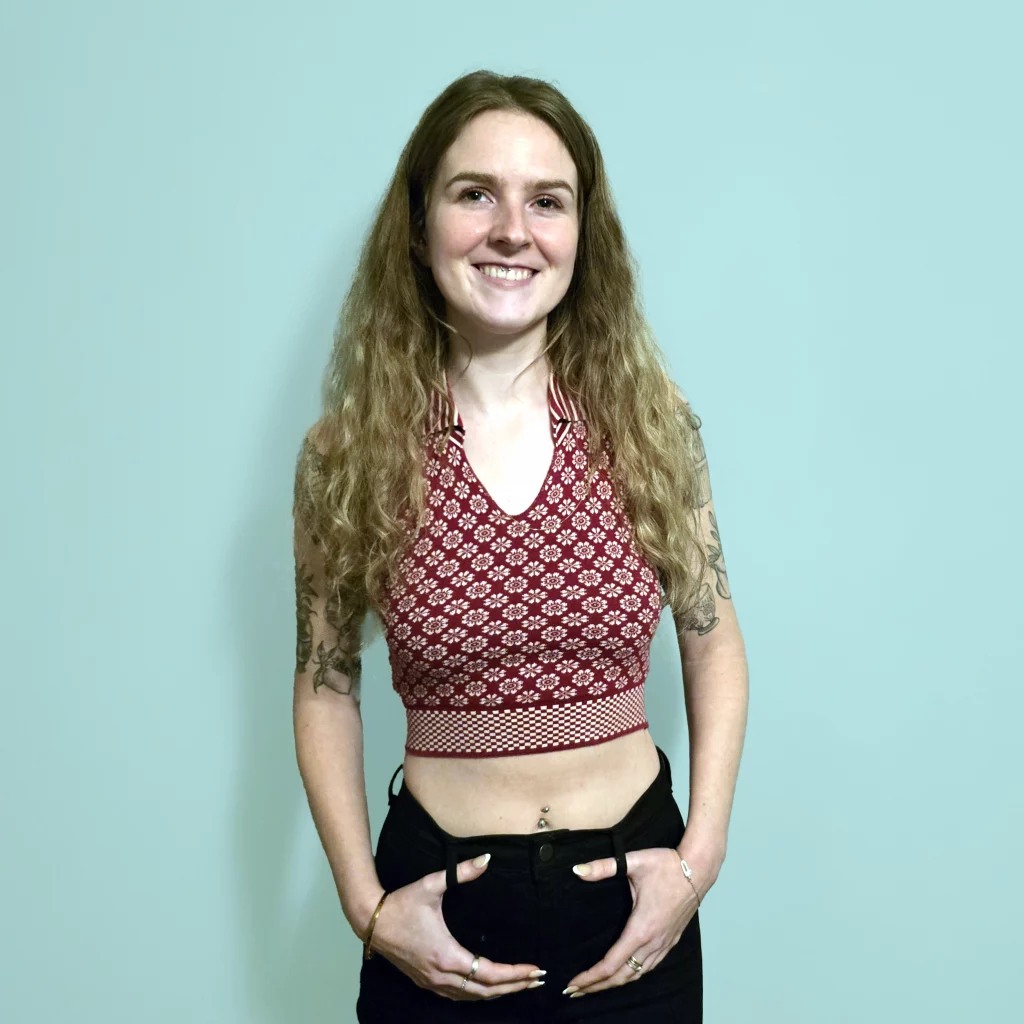 Lady wearing cropped top with flower pattern.