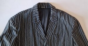 The collar and shoulders of the bone pattern Junior Gaultier jacket.