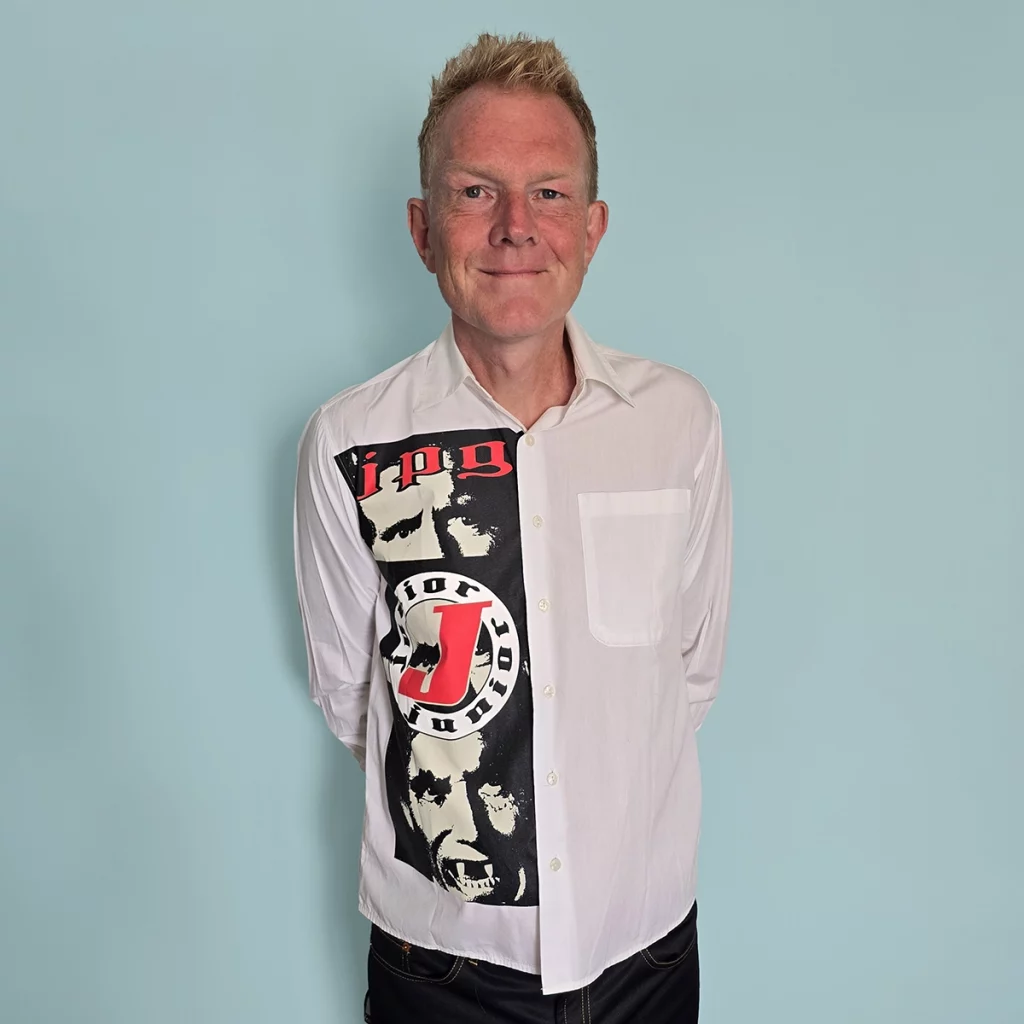 Person wearing a Junior Gaultier The Nightmare Fall Winter 1992 shirt featuring a vampire newspaper graphic and gothic lettering