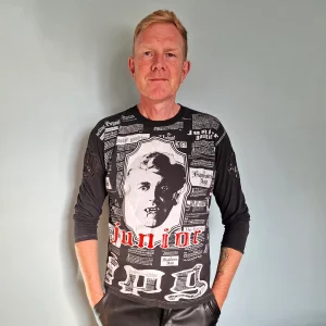 Person wearing vampire t-shirt in front of blue wall.