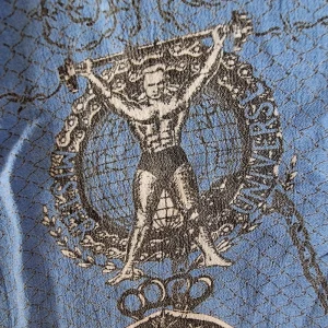 Illustration of Jean Paul Gaultier as Mister Universe on Shirt.
