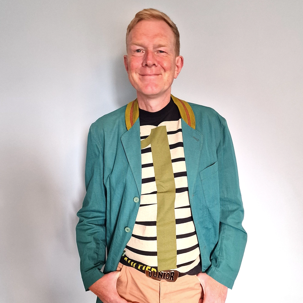 Me wearing a sriped t-shirt and blue jacket.