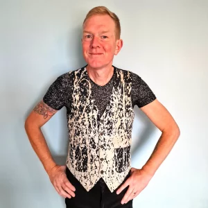 Person wearing weari g jean paul gaultier splatter waistcoat.