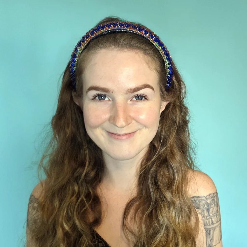 curly haired lady wearing sequin headband