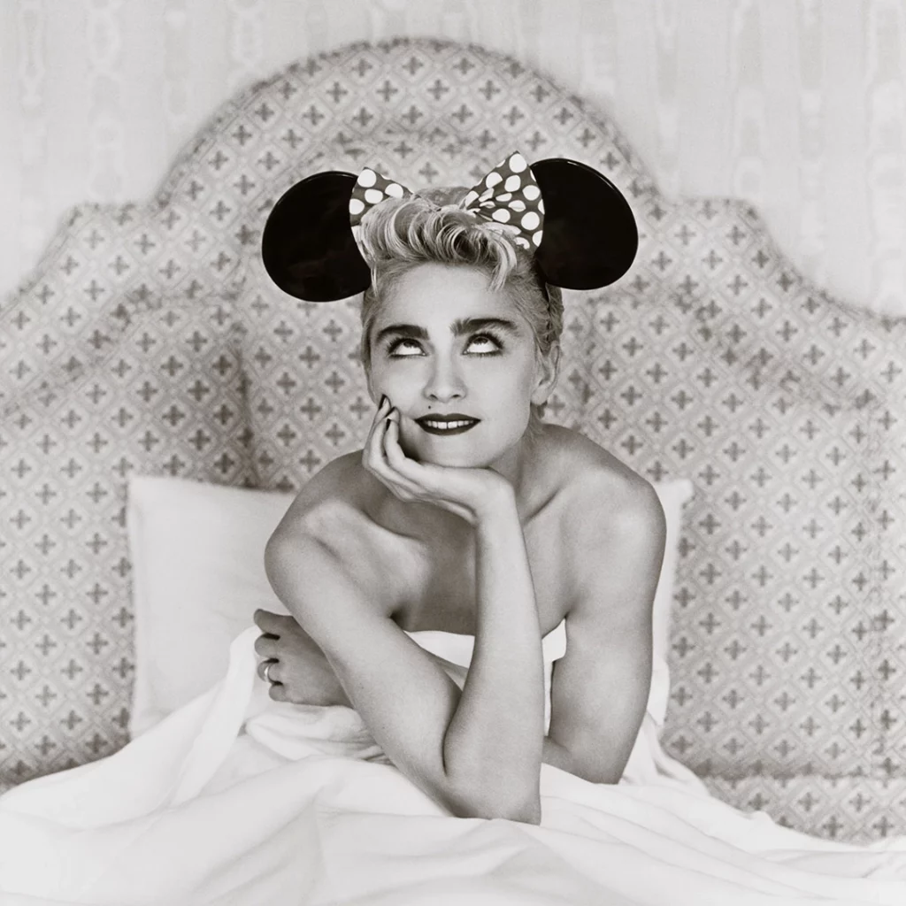 A photo of Madonna wearing Micky Mouse ears.