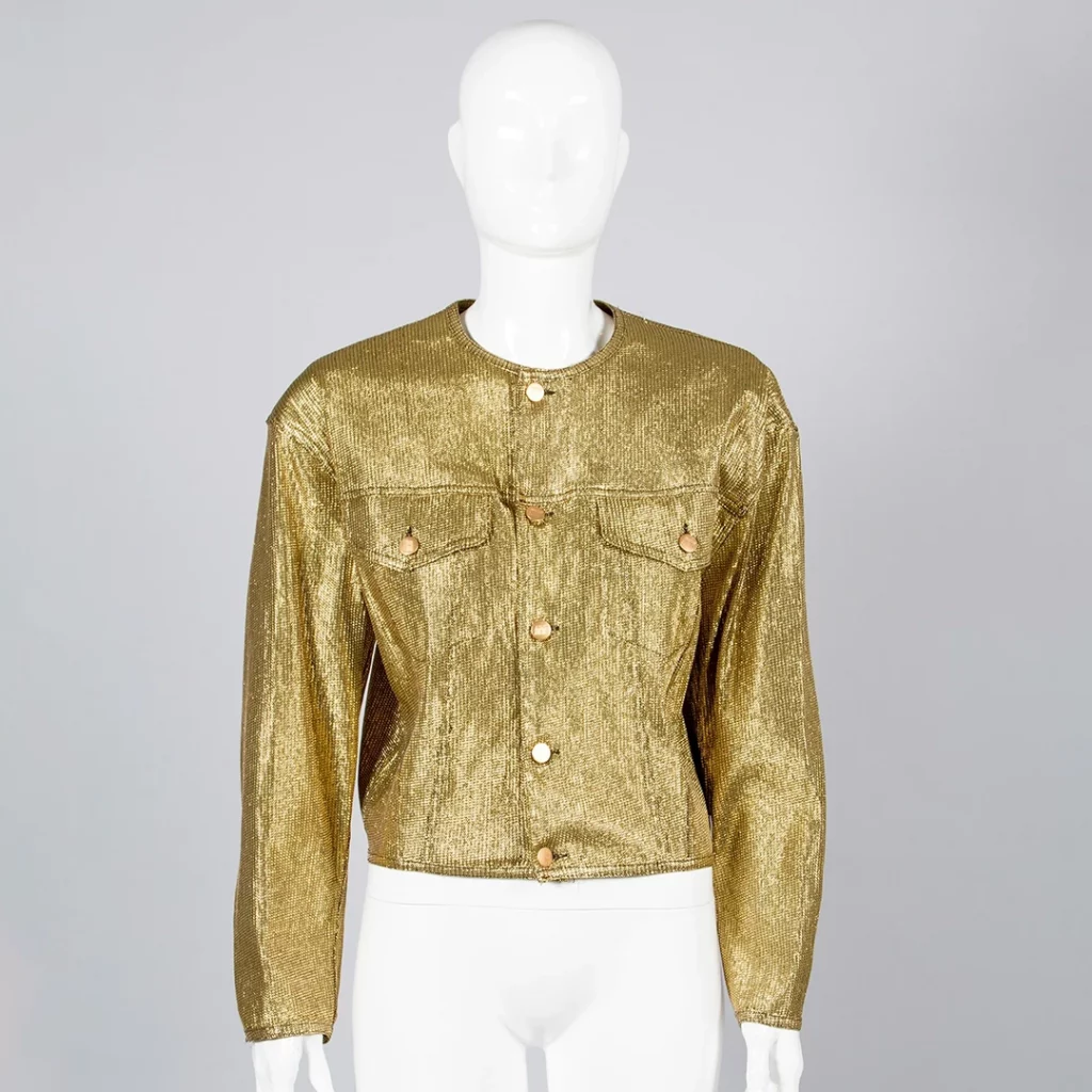 Collarless trucker jacket in gold lurex material.