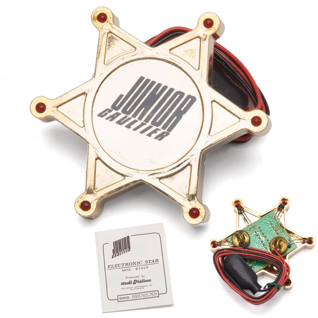 A plastic star shaped sheriff badge with LEDs.