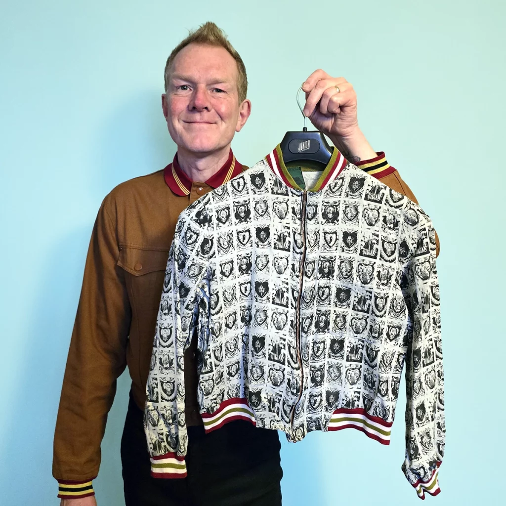 man holding jacket with icons as patterns