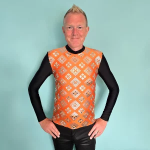 Man wearing orange top with glass gems