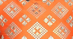 Clear gemstones on orange lycra