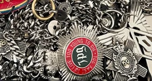 Closeup image of metal badges from Gaultier.