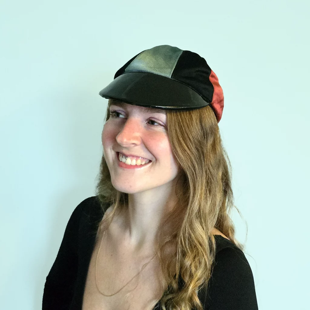 Lady wearing cap made of different coloured sections of fabric