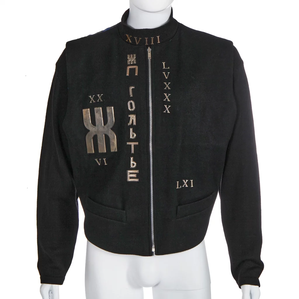 Black waistcoat with metal symbols on a mannequin.