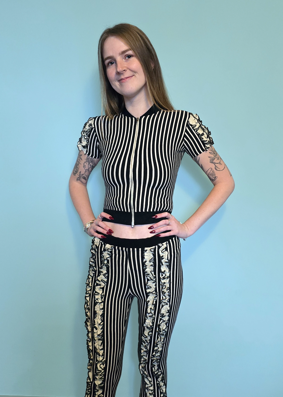 Lady wearing striped top and leggings with ruffled sections